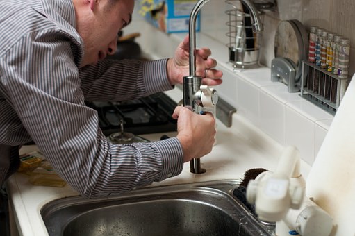 Man fixing faucet
